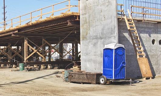 the convenience of on-site restrooms a work site lined with porta potties